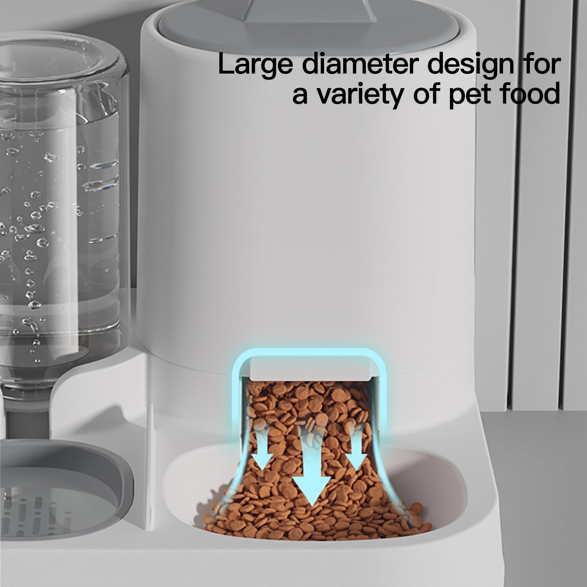 A close-up of a white automatic pet food dispenser with brown kibble falling from the food hopper. A clear water reservoir is visible on the left, and black text reads 'Large diameter design for a variety of pet food.