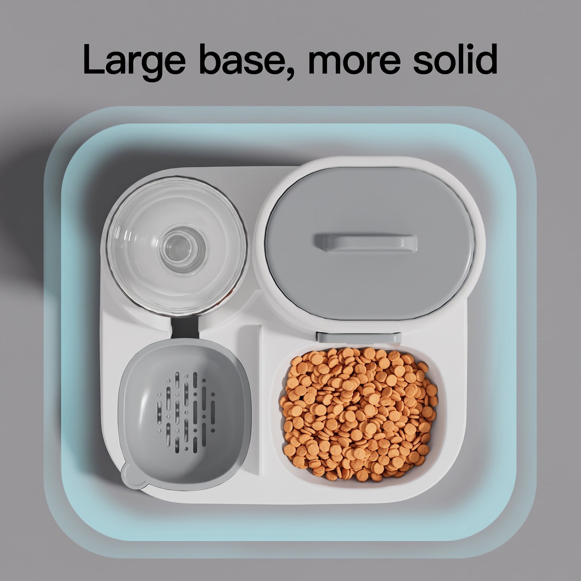 A top-down view of a white multi-compartment pet food bowl with a light blue outer shadow effect, featuring a gray lid, a clear waterer, and a compartment filled with brown kibble. The text 'Large base, more solid' is displayed at the top.