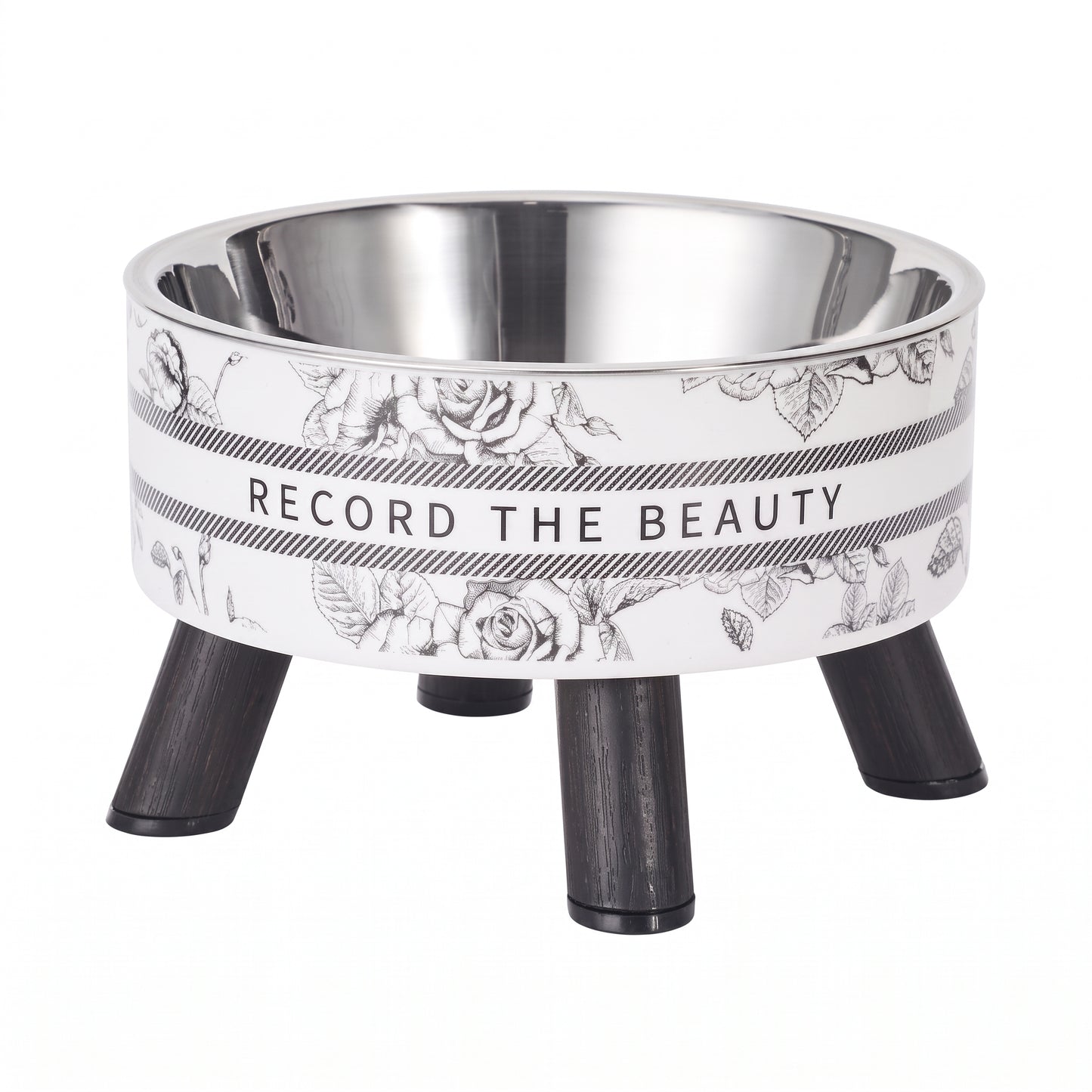 A pet elevated bowl with a stainless steel interior, a white exterior featuring black floral line art and the text 'RECORD THE BEAUTY', and three black legs, shown on a plain white background.